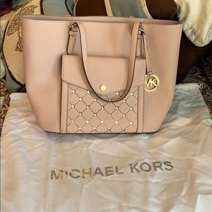 Michael Kors Blush/Pink bag with gold accents.